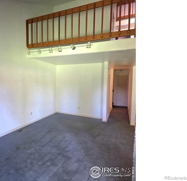 1550 W 28th St Unit 1, Loveland, CO 80538 - spare room featuring dark colored carpet and baseboards