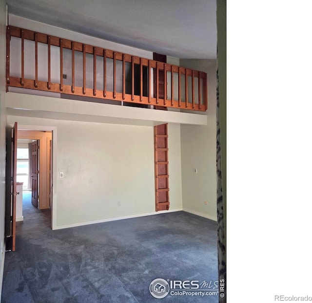 1550 W 28th St Unit 1, Loveland, CO 80538 - unfurnished room with dark colored carpet and baseboards