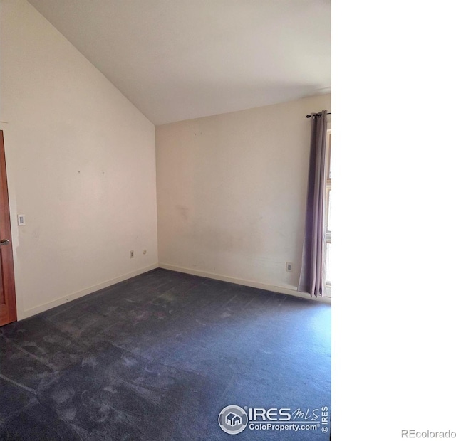 1550 W 28th St Unit 1, Loveland, CO 80538 - unfurnished room featuring dark carpet and vaulted ceiling