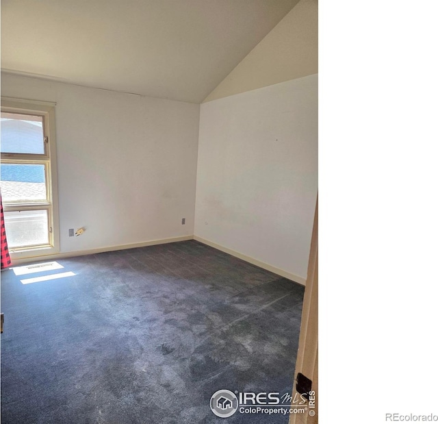 1550 W 28th St Unit 1, Loveland, CO 80538 - empty room featuring dark carpet and lofted ceiling
