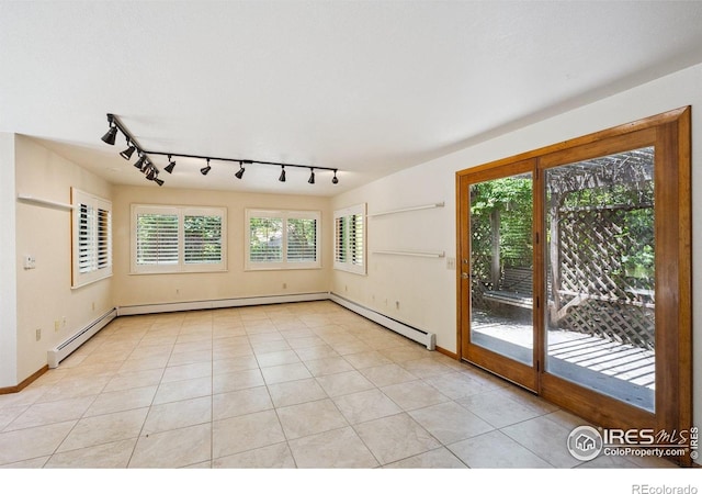 2513 Lanyon Dr, Longmont, CO 80503 - spare room featuring rail lighting, a baseboard radiator, and light tile patterned flooring