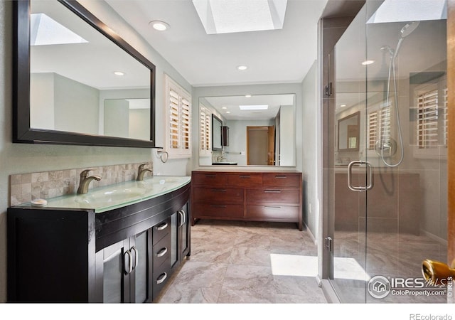 2513 Lanyon Dr, Longmont, CO 80503 - full bath with vanity, a skylight, a stall shower, marble finish floors, and tasteful backsplash