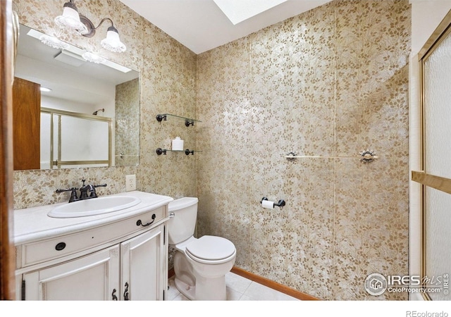 2513 Lanyon Dr, Longmont, CO 80503 - full bath with a skylight, vanity, a shower with door, and tile patterned flooring