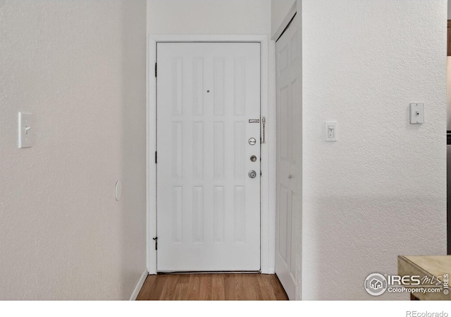 3535 28th St # 202, Boulder, CO 80301 - doorway with wood finished floors and a textured wall