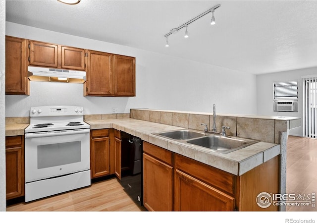 3535 28th St # 202, Boulder, CO 80301 - kitchen featuring under cabinet range hood, white electric range oven, light wood-style floors, black dishwasher, and a peninsula