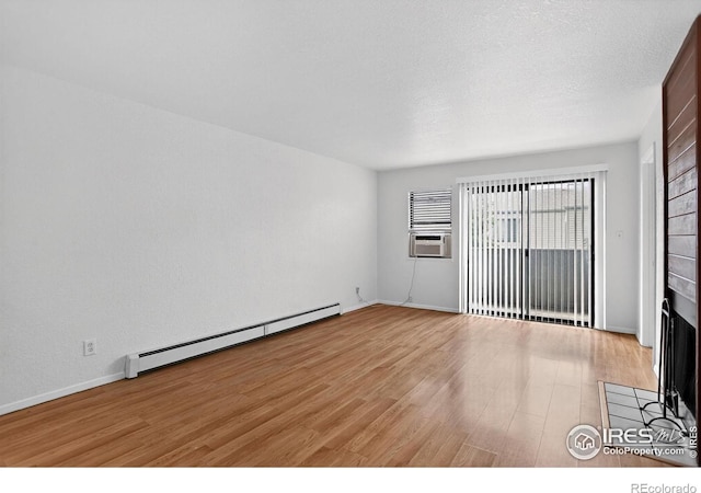 3535 28th St # 202, Boulder, CO 80301 - unfurnished room featuring a baseboard radiator, plenty of natural light, light wood-style floors, and cooling unit