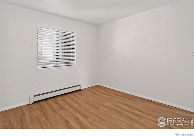 3535 28th St # 202, Boulder, CO 80301 - empty room with a baseboard heating unit and light wood-style floors