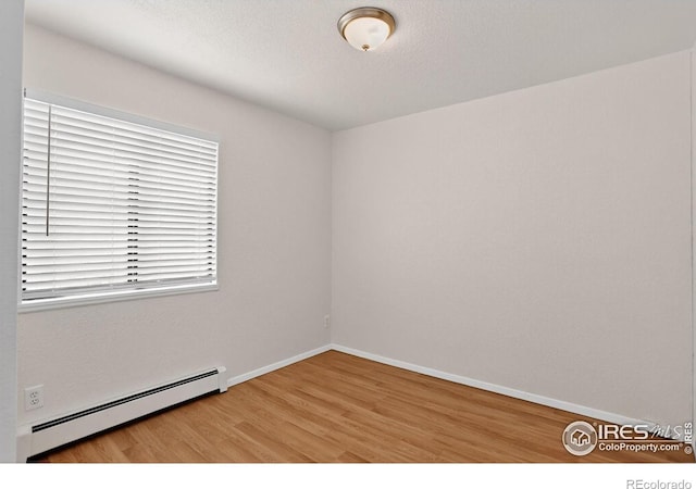 3535 28th St # 202, Boulder, CO 80301 - empty room with a baseboard heating unit and light wood-style floors