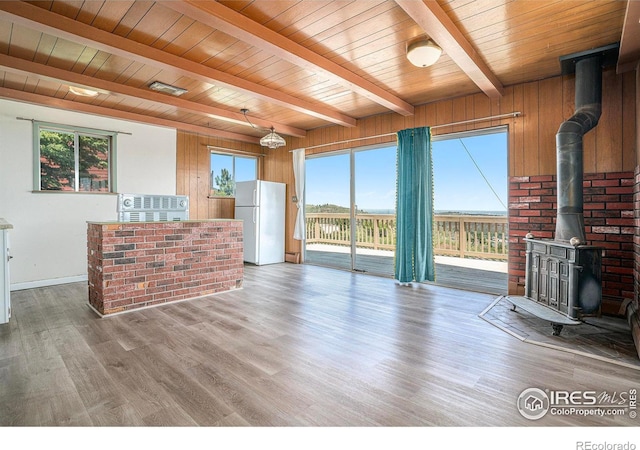 5017 Overhill Dr, Fort Collins, CO 80526 - unfurnished living room featuring a wood stove, a wooden ceiling with exposed beams, and wood finished floors