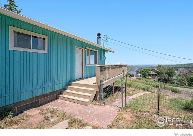 5017 Overhill Dr, Fort Collins, CO 80526 - doorway to property featuring a wooden deck and a gate