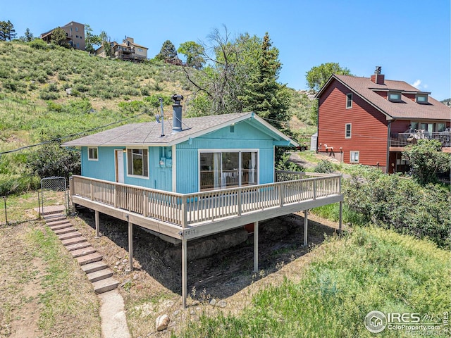 5017 Overhill Dr, Fort Collins, CO 80526 - rear view of property featuring a deck, roof with shingles, and a chimney