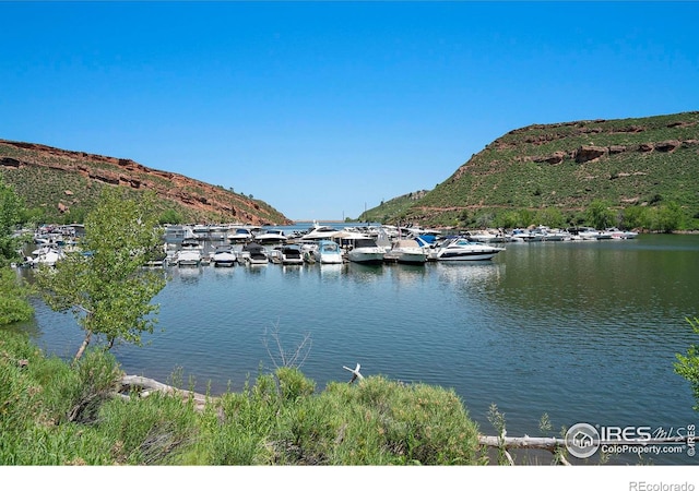 5017 Overhill Dr, Fort Collins, CO 80526 - water view with a mountain backdrop and a dock