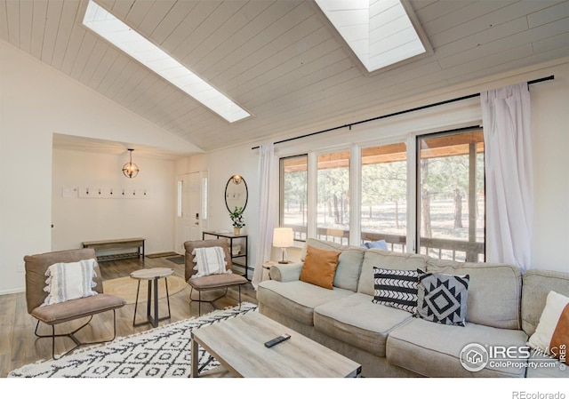 30795 W Ridge Rd, Buena Vista, CO 81211 - living room with a skylight, wood finished floors, wooden ceiling, baseboard heating, and high vaulted ceiling