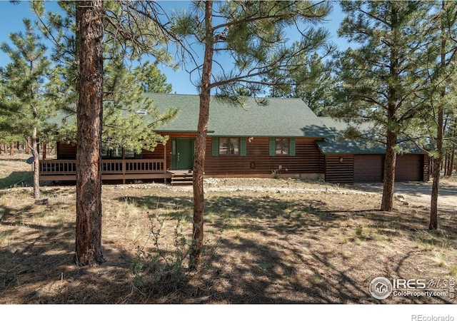 30795 W Ridge Rd, Buena Vista, CO 81211 - back of house featuring a garage, a shingled roof, a deck, and driveway