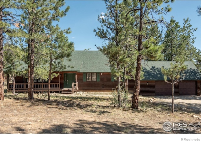 30795 W Ridge Rd, Buena Vista, CO 81211 - back of property with a shingled roof, a wooden deck, and a garage