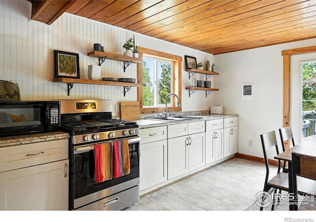 181 County Road 874, Tabernash, CO 80478 - kitchen featuring stainless steel range with gas cooktop, open shelves, wood ceiling, black microwave, and wooden walls