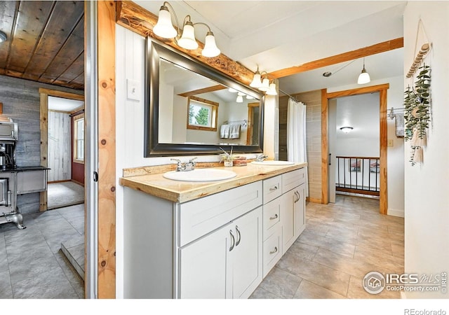 181 County Road 874, Tabernash, CO 80478 - full bath featuring wooden walls, double vanity, and beam ceiling