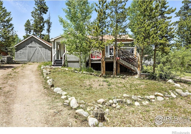 181 County Road 874, Tabernash, CO 80478 - view of front of home with stairs, an outbuilding, a wooden deck, and dirt driveway
