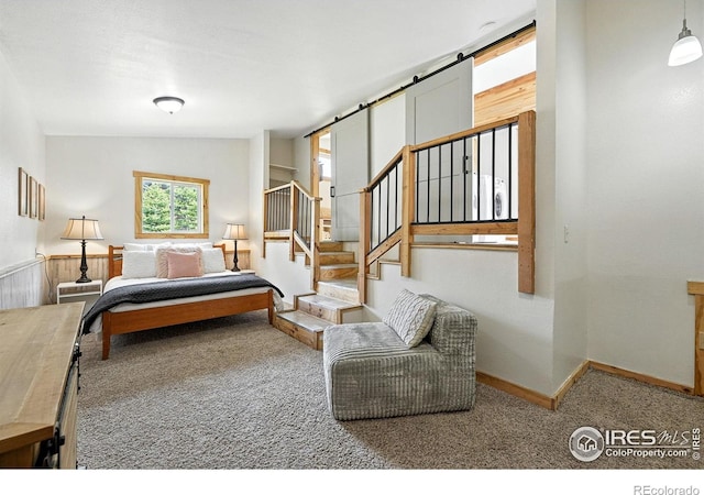 181 County Road 874, Tabernash, CO 80478 - carpeted bedroom featuring a barn door and baseboards