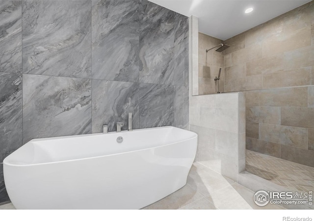 37 Wagner Cir, Boulder, CO 80304 - bathroom featuring tile walls, a soaking tub, a walk in shower, tile patterned flooring, and recessed lighting