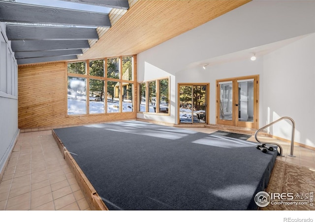 37 Wagner Cir, Boulder, CO 80304 - unfurnished living room with light tile patterned floors, vaulted ceiling, and wooden walls