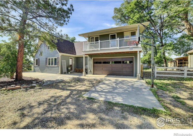10930 N 85th St, Longmont, CO 80503 - view of front of property featuring driveway, a balcony, and an attached garage