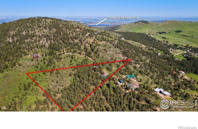 451 Newell Dr, Loveland, CO 80537 - aerial overview of property's location with property parcel outlined and a mountain backdrop