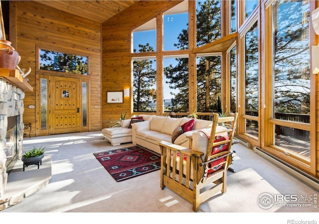 451 Newell Dr, Loveland, CO 80537 - sunroom featuring high vaulted ceiling, wooden ceiling, wooden walls, carpet flooring, and a baseboard heating unit
