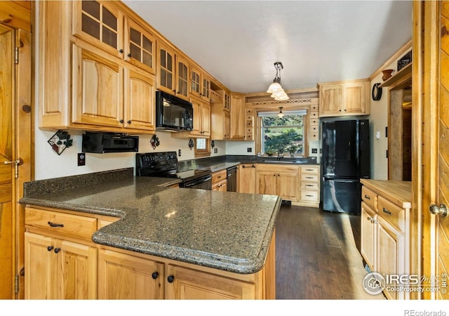 451 Newell Dr, Loveland, CO 80537 - kitchen featuring black appliances, glass insert cabinets, dark wood-style flooring, a peninsula, and pendant lighting