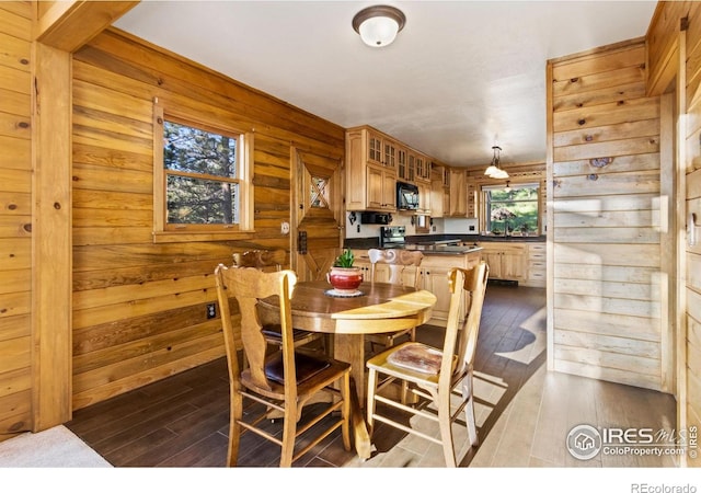 451 Newell Dr, Loveland, CO 80537 - dining space featuring dark wood finished floors and wood walls