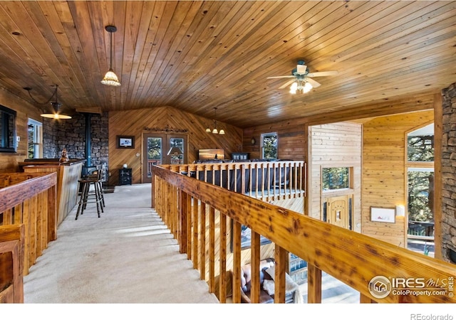 451 Newell Dr, Loveland, CO 80537 - corridor with an upstairs landing, healthy amount of natural light, wood walls, carpet, and wood ceiling