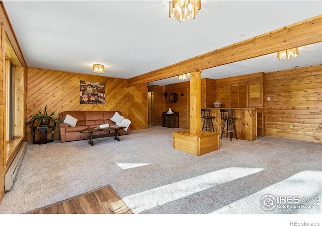 451 Newell Dr, Loveland, CO 80537 - living room featuring wood walls, bar, carpet flooring, and a baseboard radiator