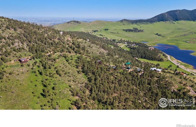 451 Newell Dr, Loveland, CO 80537 - drone / aerial view of a mountain backdrop and a heavily wooded area