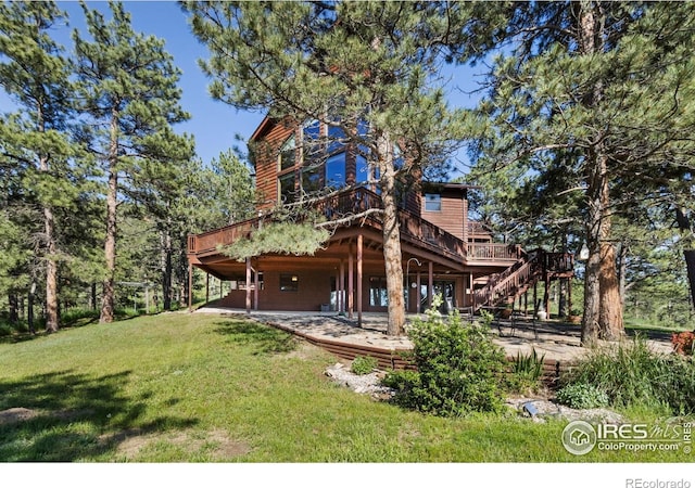 451 Newell Dr, Loveland, CO 80537 - rear view of property featuring a deck, a lawn, stairs, and a patio
