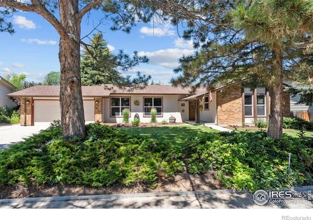 607 42nd Ave, Greeley, CO 80634 - ranch-style home with a garage, driveway, brick siding, and a front lawn