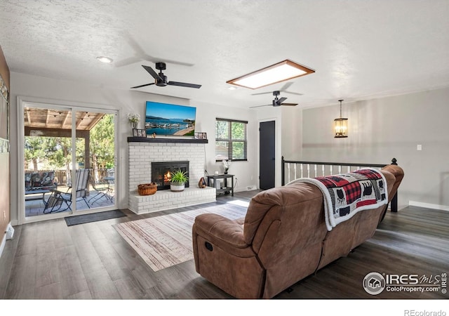 607 42nd Ave, Greeley, CO 80634 - living room with a ceiling fan, wood finished floors, a fireplace, and a textured ceiling