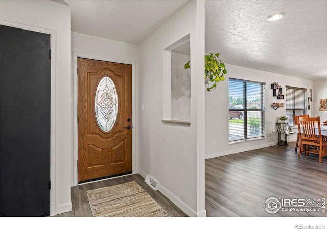 607 42nd Ave, Greeley, CO 80634 - foyer featuring wood finished floors and a textured ceiling