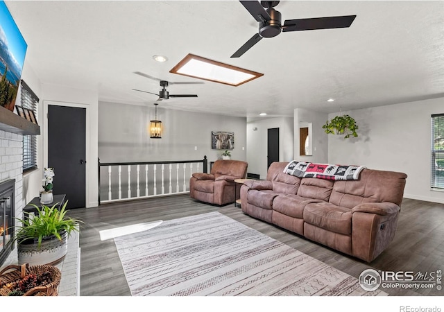 607 42nd Ave, Greeley, CO 80634 - living area with ceiling fan, recessed lighting, wood finished floors, a skylight, and a brick fireplace