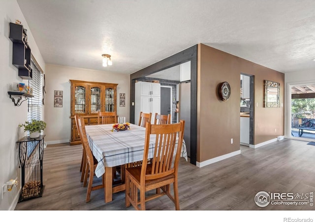 607 42nd Ave, Greeley, CO 80634 - dining room featuring a textured ceiling and wood finished floors