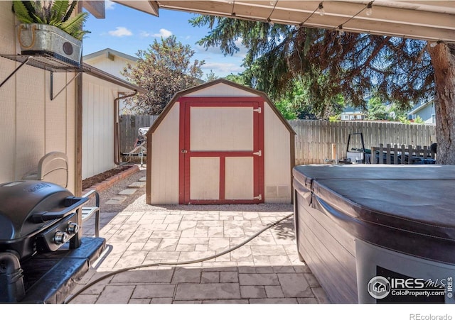 607 42nd Ave, Greeley, CO 80634 - fenced backyard featuring a hot tub, a patio area, a storage shed, and a grill