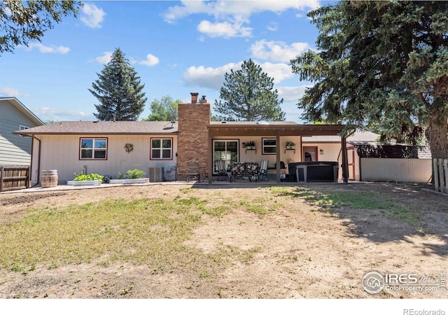 607 42nd Ave, Greeley, CO 80634 - back of house featuring a chimney, a patio, and a storage unit