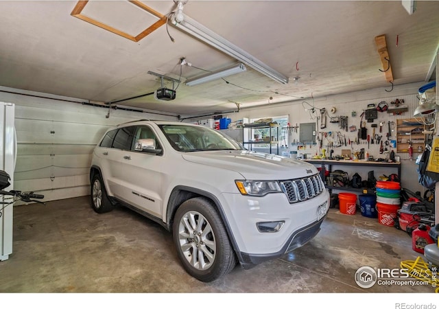 607 42nd Ave, Greeley, CO 80634 - garage featuring a garage door opener and electric panel