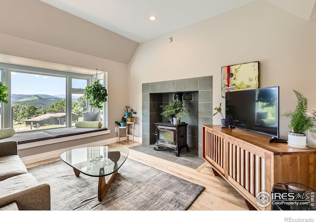 4815 Sugarloaf Rd, Boulder, CO 80302 - living room with a wood stove, vaulted ceiling, wood finished floors, and recessed lighting
