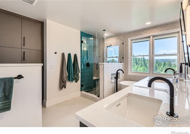 4815 Sugarloaf Rd, Boulder, CO 80302 - full bath featuring a shower stall, double vanity, a soaking tub, and tile patterned flooring
