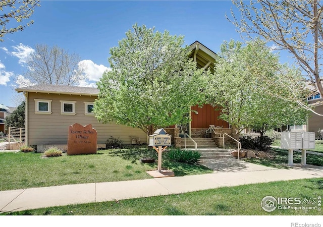 193 2nd Ave Unit A, Lyons, CO 80540 - view of property hidden behind natural elements with board and batten siding and a front yard