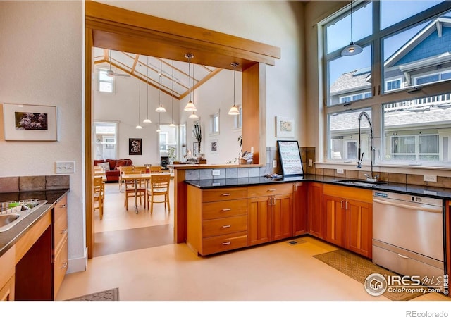 193 2nd Ave Unit A, Lyons, CO 80540 - kitchen featuring dishwasher, high vaulted ceiling, brown cabinets, hanging light fixtures, and open floor plan