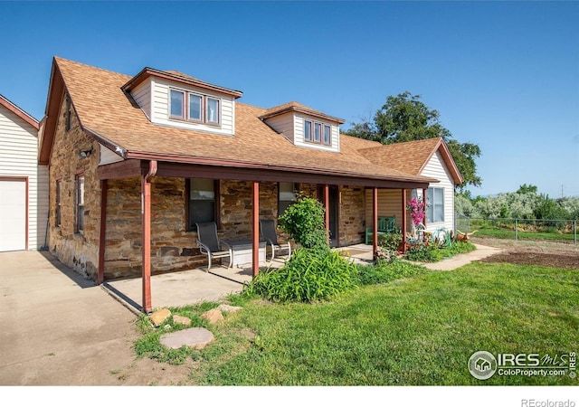 7035 S Boulder Rd, Boulder, CO 80303 - view of front of home with stone siding, a shingled roof, a garage, and a porch