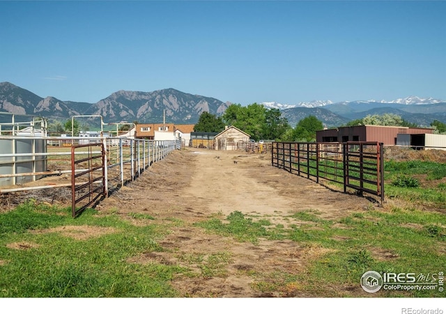 7035 S Boulder Rd, Boulder, CO 80303 - view of yard featuring an exterior structure, a mountain view, an outbuilding, and a view of rural / pastoral area