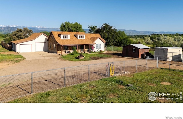 7035 S Boulder Rd, Boulder, CO 80303 - view of front facade featuring driveway, a mountain view, and an outbuilding
