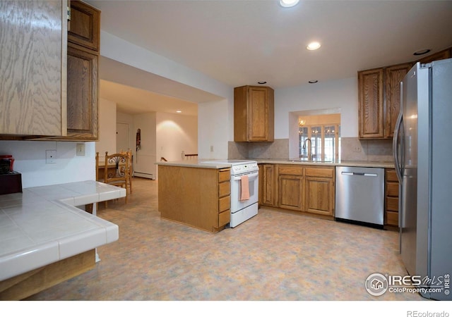 7035 S Boulder Rd, Boulder, CO 80303 - kitchen featuring appliances with stainless steel finishes, recessed lighting, a peninsula, backsplash, and brown cabinetry